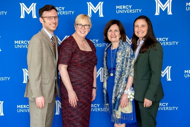 CNR Legacy Award recipient Pat Keegan Abels and her two children pose with Mercy University President Susan L. Parish