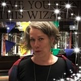 Self behind Have You Seen This Wizard sign, with stars.