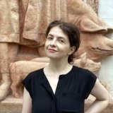 Ekaterina Dubovitskaya standing against a relief