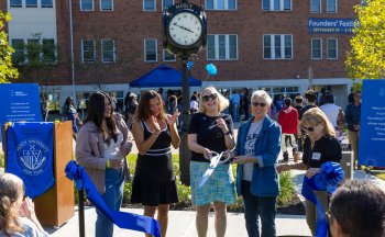 Mercy University president, faculty and student cut the ribbon for the new clock dedicated during Founders' Festival 2025 in honor of the 75th anniversary