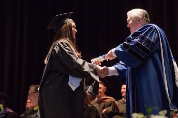 President Hall and graduate