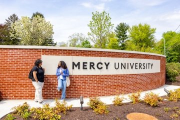 Mercy University Westchester Campus entrance with 2 students in front