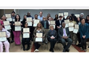 Mercy University mediation training program participants holding up their certificates
