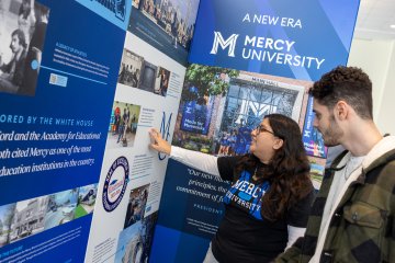 Mercy University students checking out the 75th Anniversary Exhibit