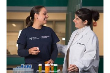 Occupational Therapy student and faculty in the lab