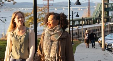 Diverse students walking to campus together.