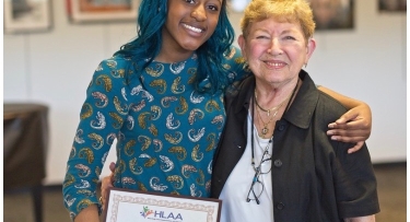 Jolissa Louissant receiving a scholarship from the Westchester chapter of the Hearing Loss Association of America (HLAA)