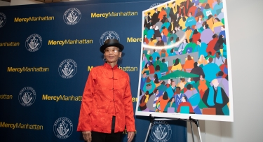 Synthia SAINT JAMES with her painting "UNSTOPPABLE" at MercyManhatta