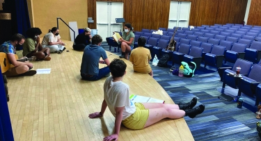 Actors rehearsing on stage at Mercy College