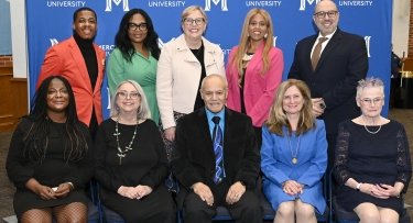 Mercy University President posed with Alumni of Distinction Honorees