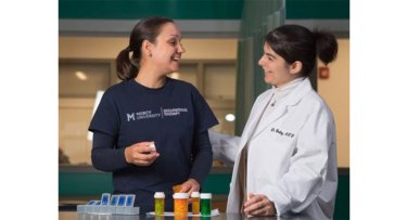 Occupational Therapy student and faculty in the lab