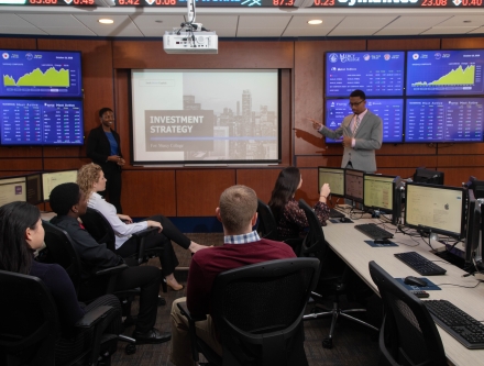 Business students presenting in Mercy trading room