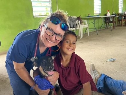 Faculty in Belize with dog and Child