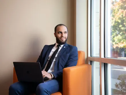 business student sitting with laptop