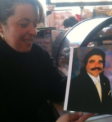 Eleni holding a photo of her father