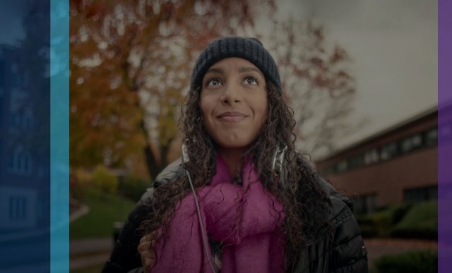 Woman with hat and scarf looking upward
