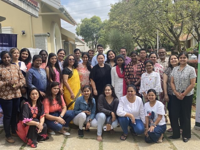 Mercy University professors pose with group of teachers they trained from Behavior Momentum India, network of private clinics across India that serve children with autism.  a net