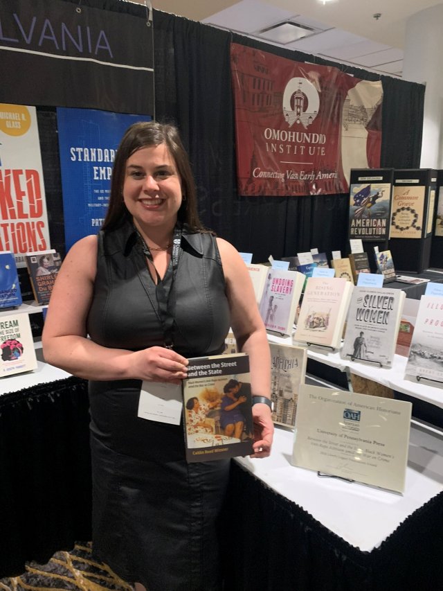Assistant Professor Caitlin Wiesner with her book and Liberty Legacy Foundation Award