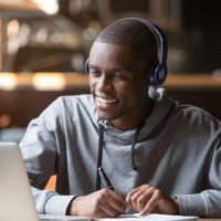 Student with headphones and laptop